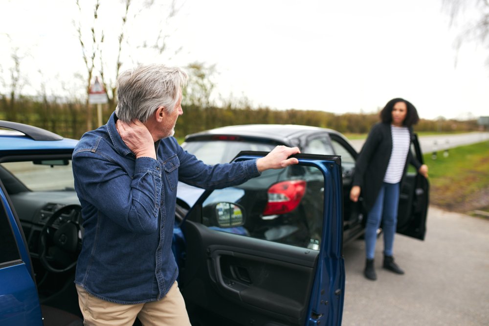 Senior,Male,And,Younger,Female,Drivers,Get,Out,Of,Cars auto accident